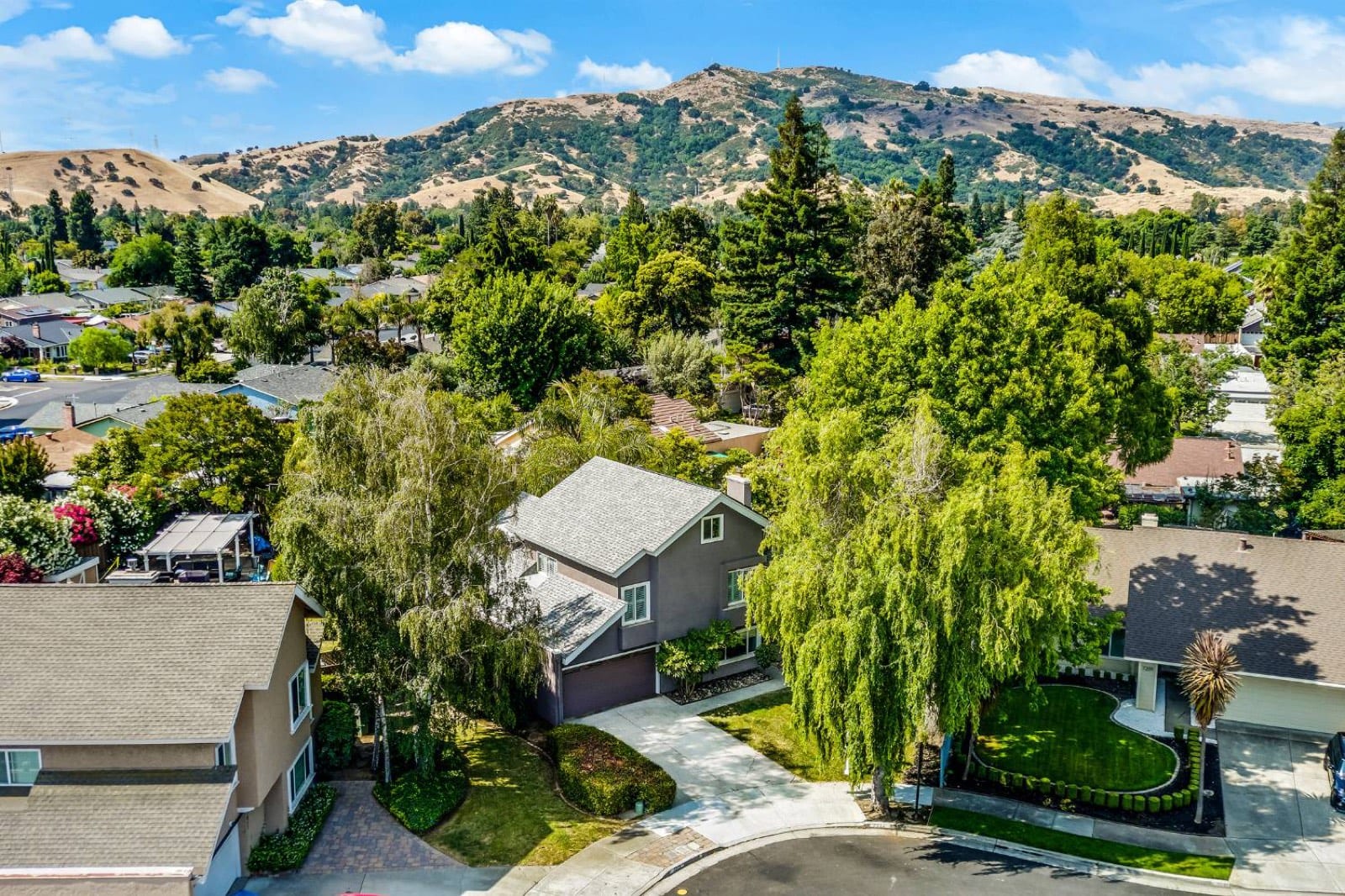 Aerial view of the home on its cul-de-sac with the East Foothills behind