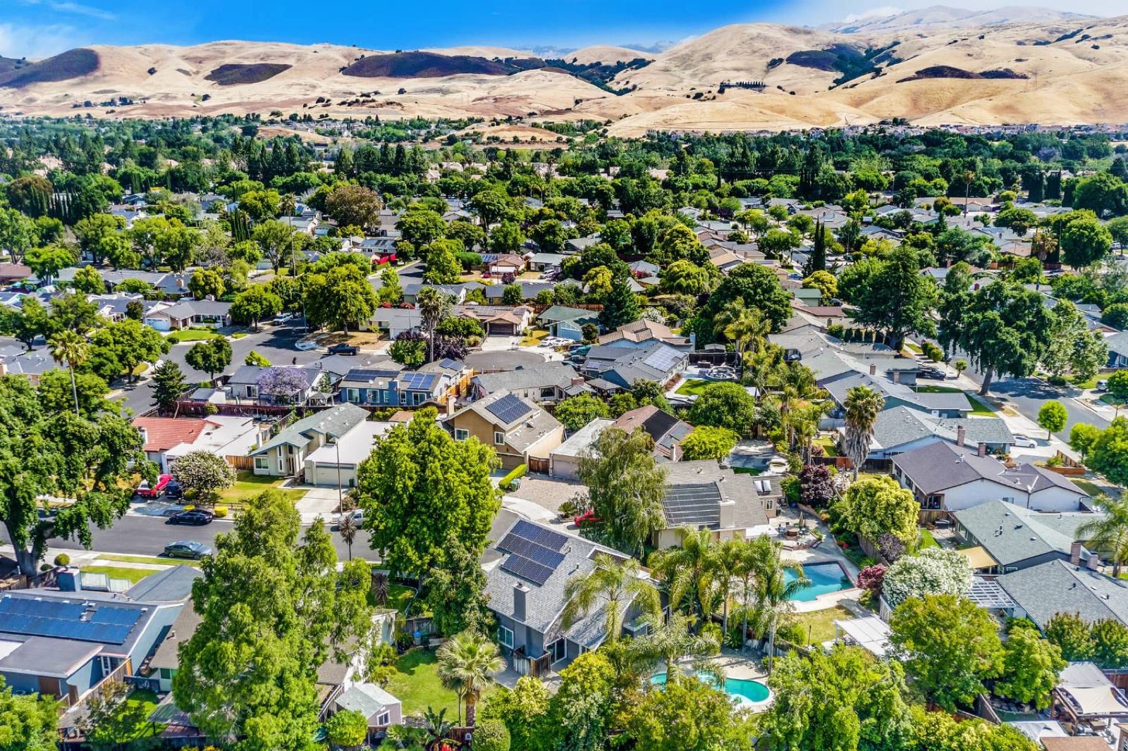 Aerial view of the neighborhood with the golden foothills on the horizon